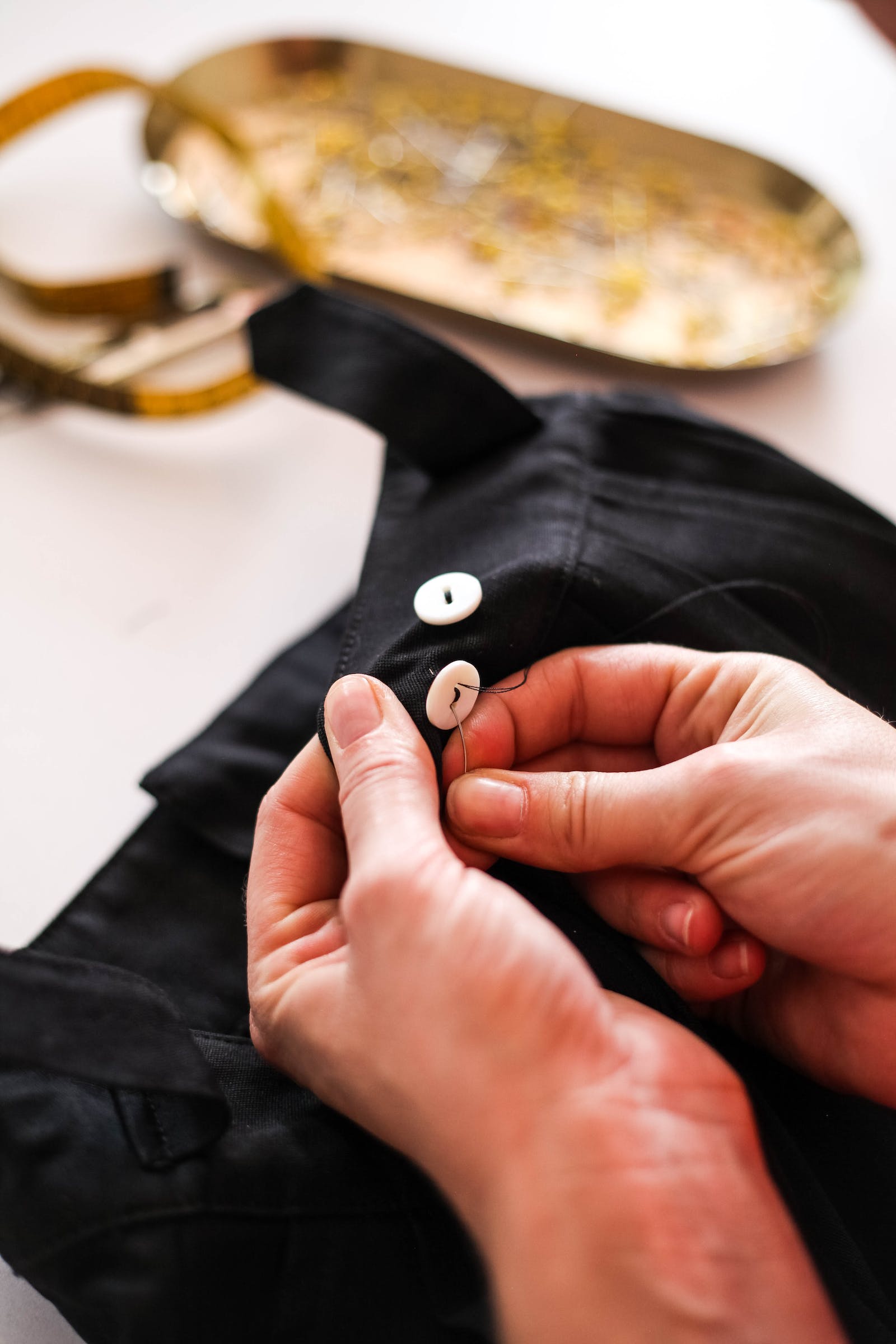 Professional seamstress working on clothing alterations at Nimble Needle